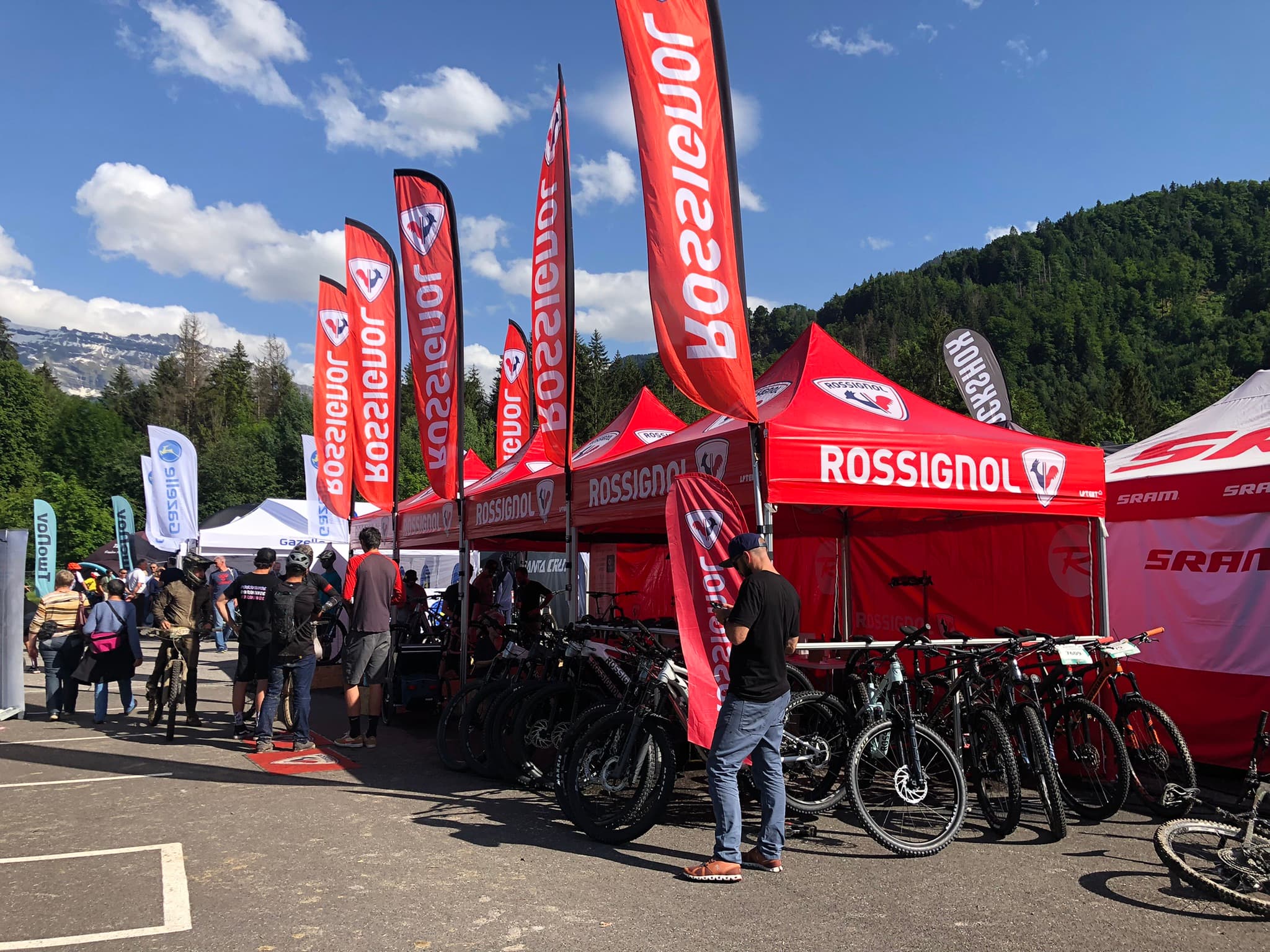 Rossignol-branded LP Tent pop-up gazebos at an outdoor cycling event in the Alps