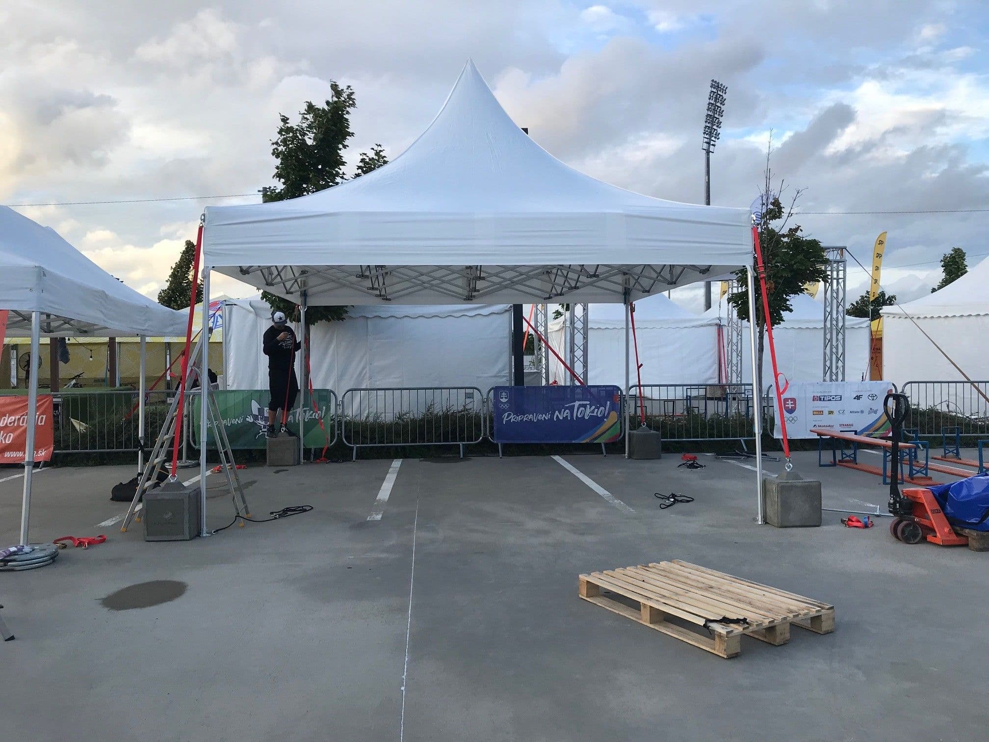 Professional white pop-up tent being installed outdoors